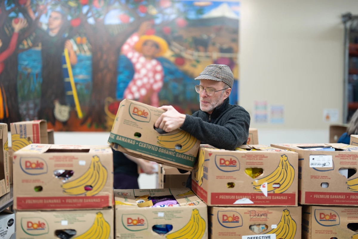 A volunteer packs items for distribution at the Oregon Food Bank in Portland on Wednesday.