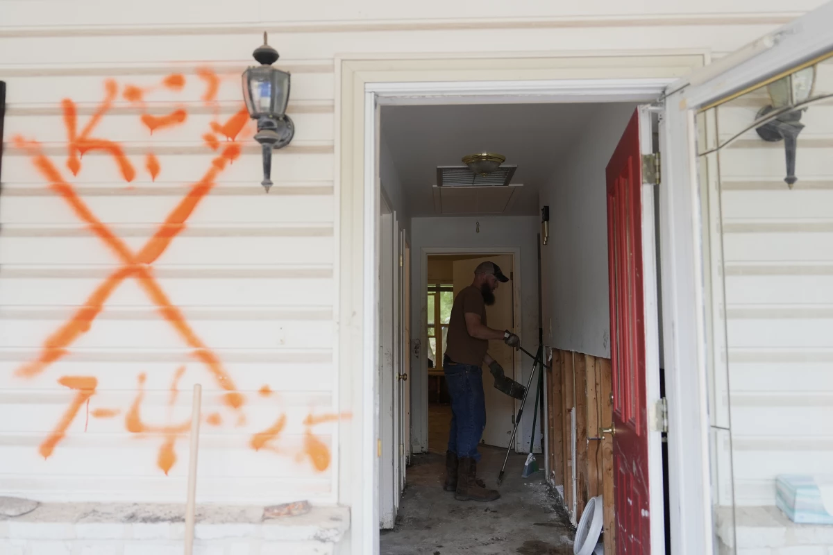 Volunteers help clean up a house after flooding in Kerrville, Texas. The state's governor and top emergency official are on a board considering options to eliminate the Federal Emergency Management Agency, at the request of President Trump.