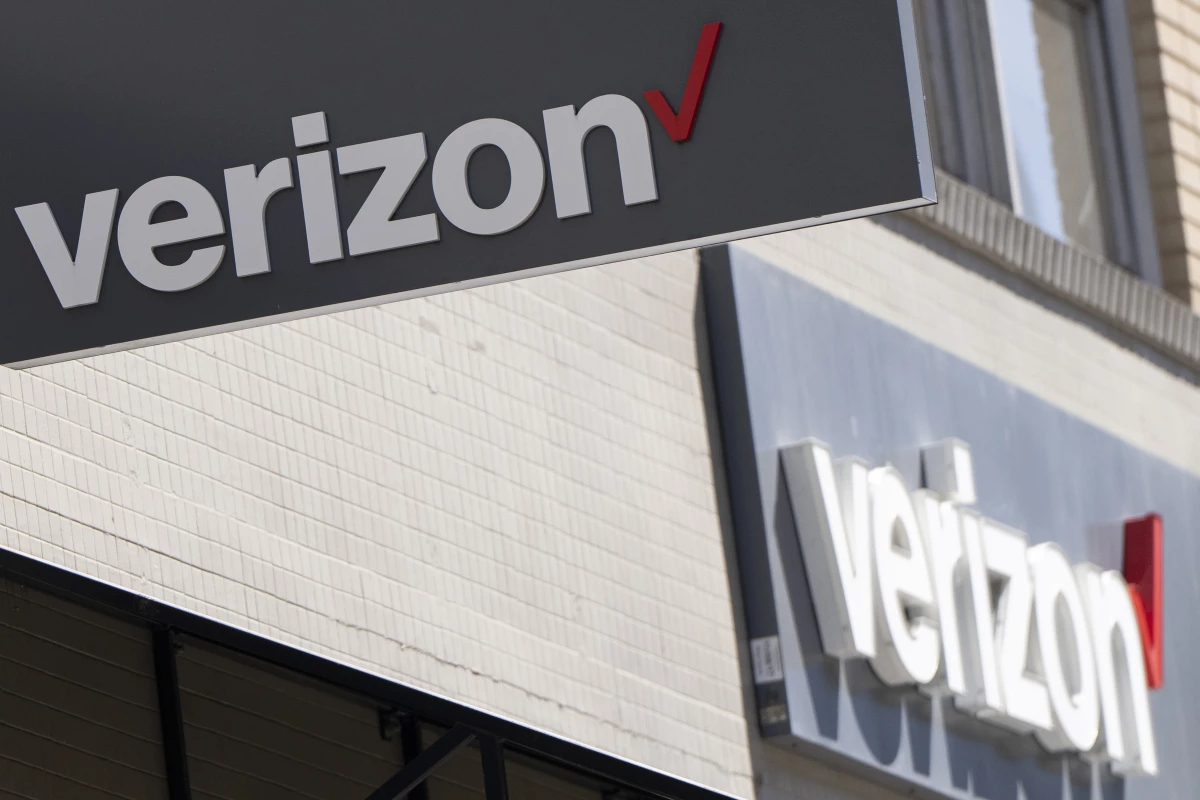 Signs are displayed outside a Verizon retail location on May 14, 2024, in Portland, Ore.