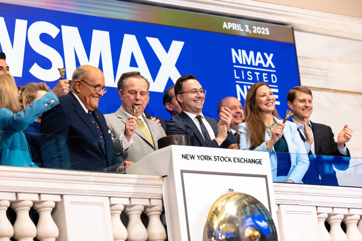 Newsmax will pay $67 million to Dominion Voting Systems to settle a lawsuit over the network's coverage of the 2020 presidential election. In this photo from April 3, 2025, Newsmax CEO Chris Ruddy and former New York City Mayor Rudy Giuliani join others at the opening of trading at the New York Stock Exchange.