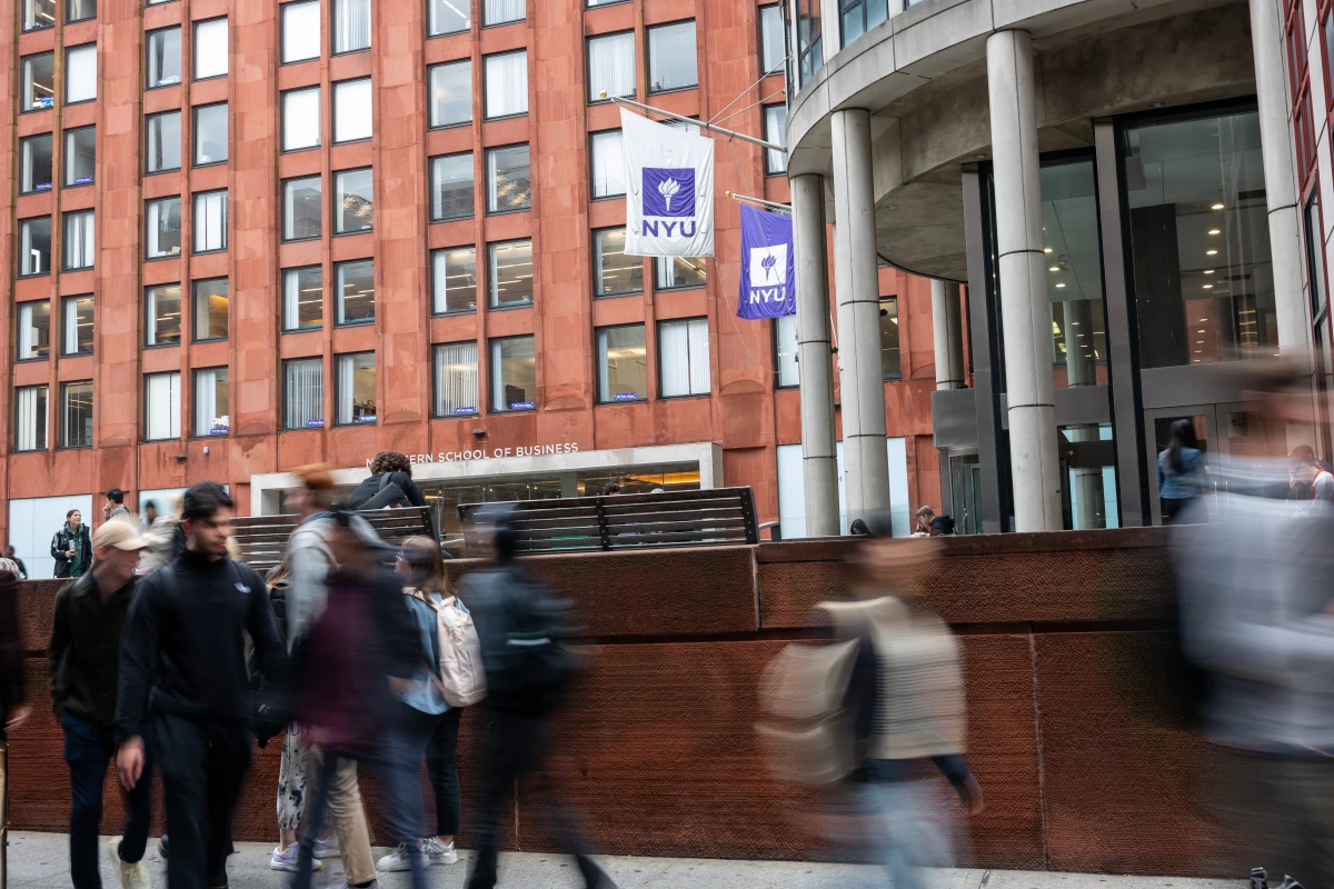 People walk by New York University in October 2023 in New York City. The university has a large international student enrollment.