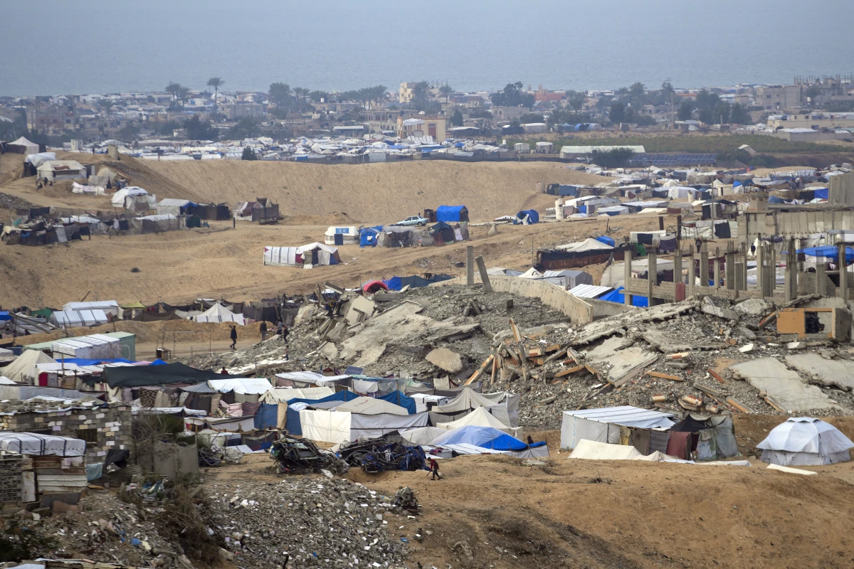 A tent camp for displaced Palestinians stands amid destroyed buildings in the Khan Younis refugee camp, in the southern Gaza Strip, on Jan. 4.
