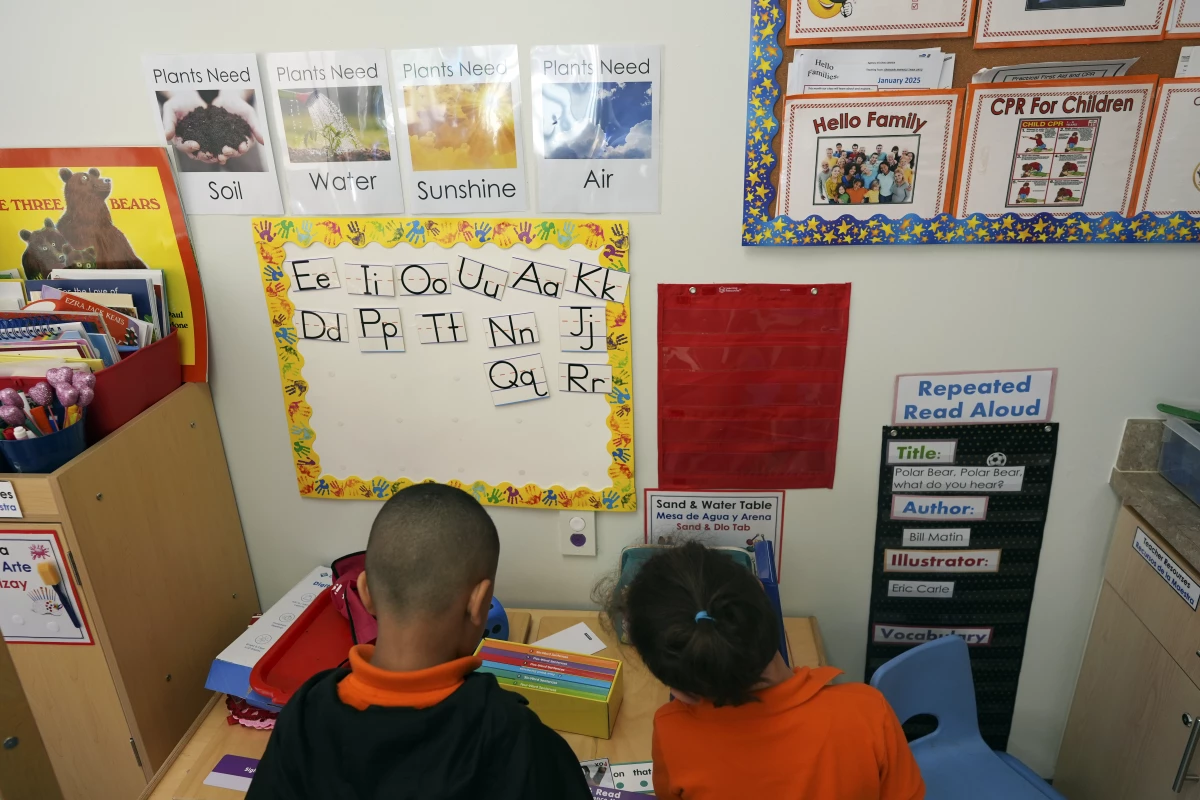 Students help put away supplies at the end of a reading and writing lesson at the Head Start program run by Easterseals, an organization that gets about a third of its funding from the federal government, on Jan. 29, in Miami.