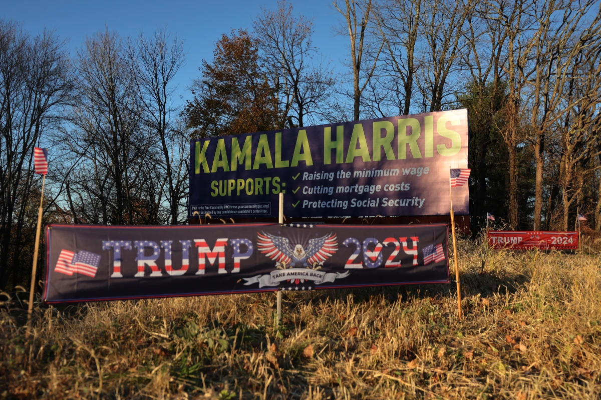 Signs for former President Donald Trump and Vice President Harris are seen on Route 33 in Bartonsville, Pa., on Nov. 2, 2024.