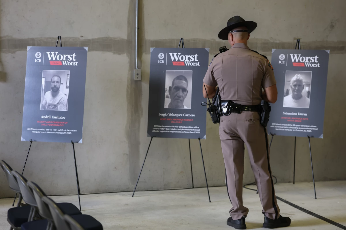 A Florida Highway Patrol officer looks at pictures of undocumented immigrants accused of crimes before a press conference at the ICE Enforcement and Removal Operations building on November 13, 2025 in Miramar, Florida. Florida law enforcement agencies have among the highest ICE cooperation rates in the nation, with state troopers making a significant number of immigration arrests.