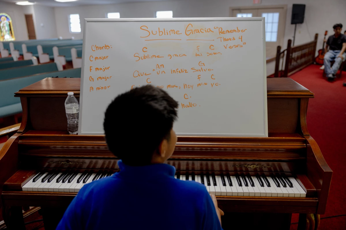 Ezdras Ambrocio Gonzalez practices a song on the piano for Sunday's church service, Saturday, May 10, 2025, in Tampa, Florida.
(Lexi Parra for NPR)