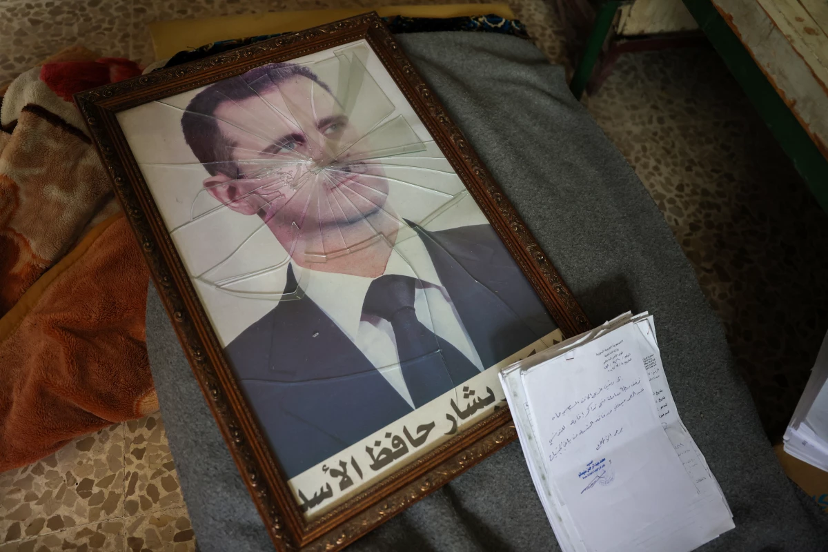 A portrait of Syrian President Bashar al-Assad with its frame broken, in the Political Security Branch facility on the outskirts of the central city of Hama, following the capture of the area by anti-government forces this past weekend.