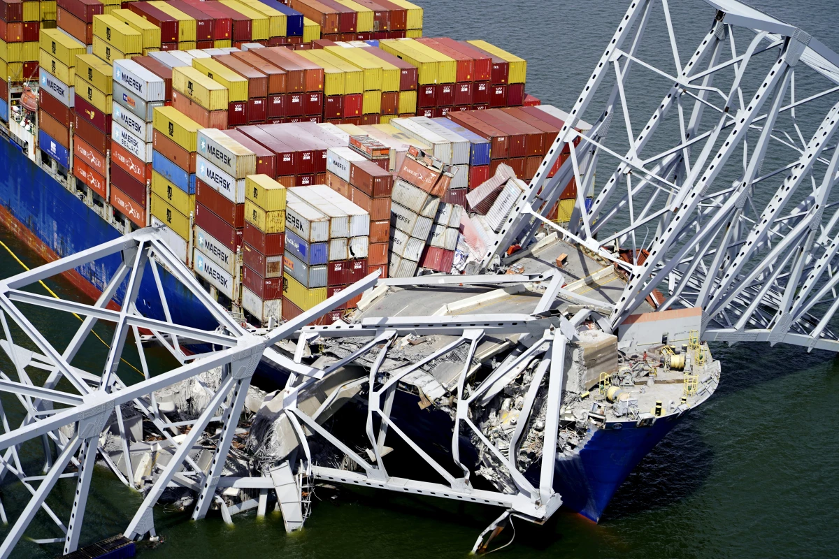 In this aerial image released by the Maryland National Guard, the cargo ship Dali is stuck under part of the structure of the Francis Scott Key Bridge after the ship hit the bridge, March 26, 2024, in Baltimore.