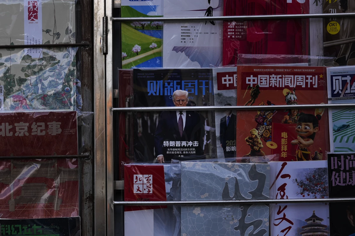 A magazine carrying a front cover of President Donald Trump with the words 'Trump shock again' on display with other magazines at a bookstand in Beijing on Tuesday, Feb. 4.