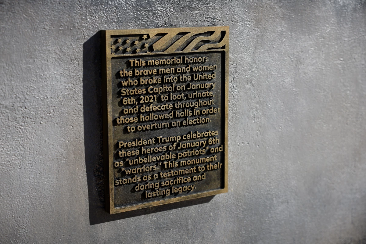 The plaque on the desk sculpture pays what appears to be a mocking tribute to the people who stormed the Capitol on Jan. 6.