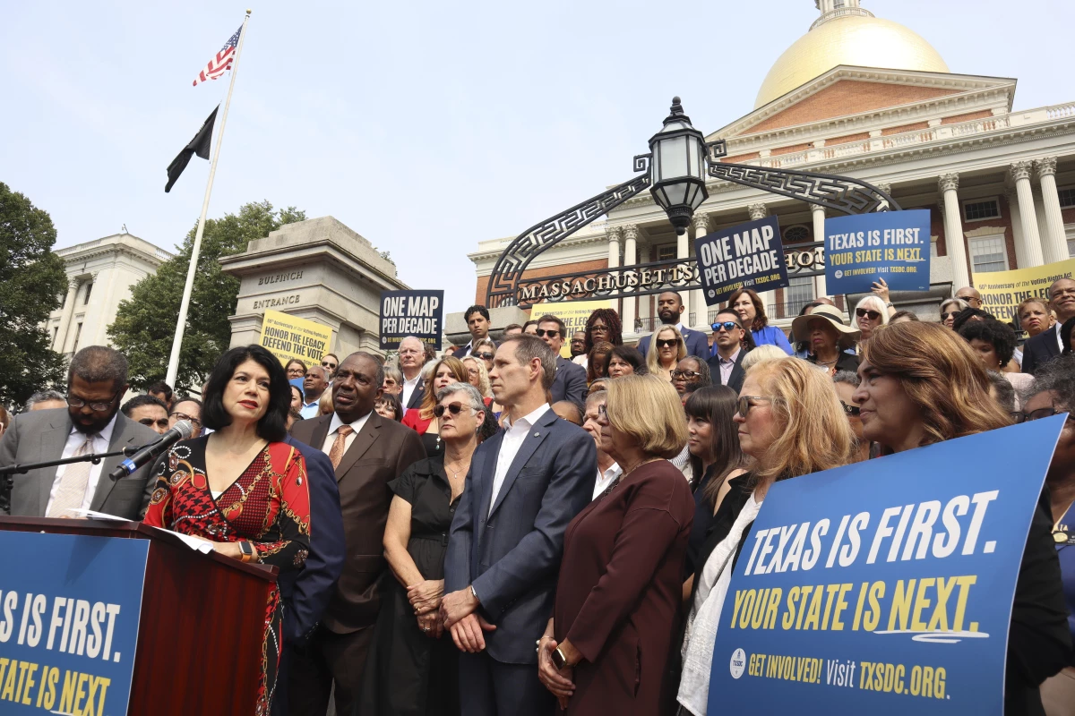 Texas state Senator Carol Alvarado, a Democrat, speaks in a crowd of other Democratic state lawmakers outside the Massachusetts State House on Wednesday, Aug. 6, 2025 in Boston.
