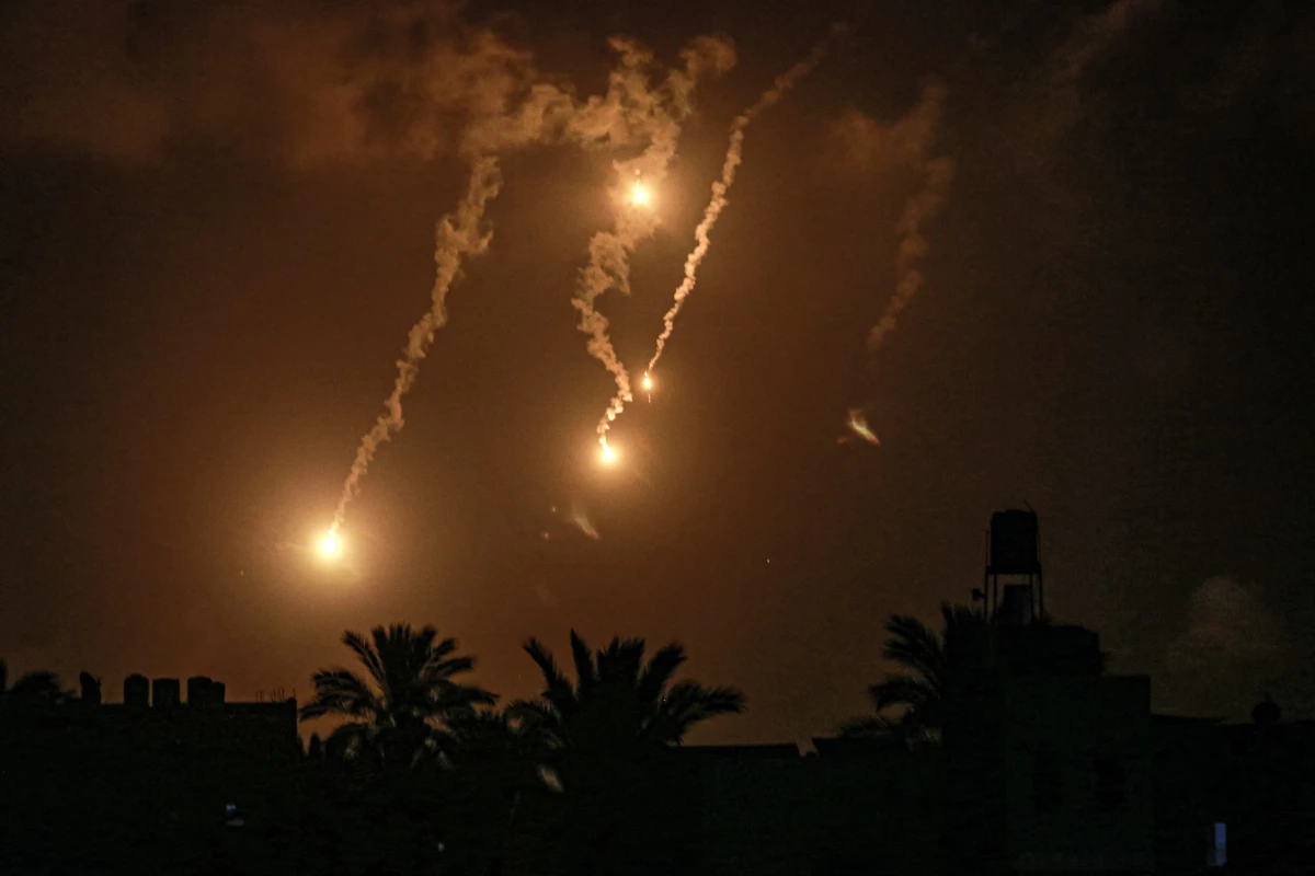 Flares fired by the Israeli military north of Nuseirat are pictured from Deir el-Balah in the central Gaza Strip late on July 1.
