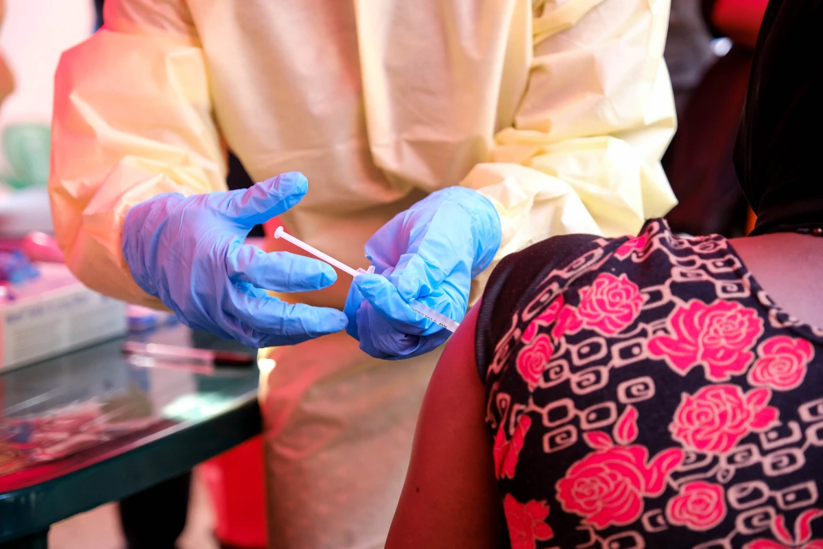 A member of a medical team at Mulago Referral Hospital in Kampala, Uganda, administers a dose of a trial Ebola vaccine to a patient on Feb. 3. The country is currently experiencing an Ebola outbreak.