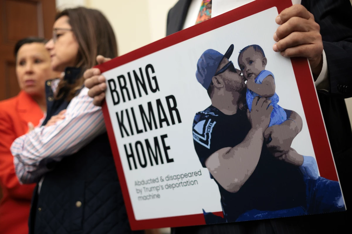 A member of the Congressional Hispanic Caucus holds a picture of Kilmar Abrego Garcia during a news conference on April 9, 2025.