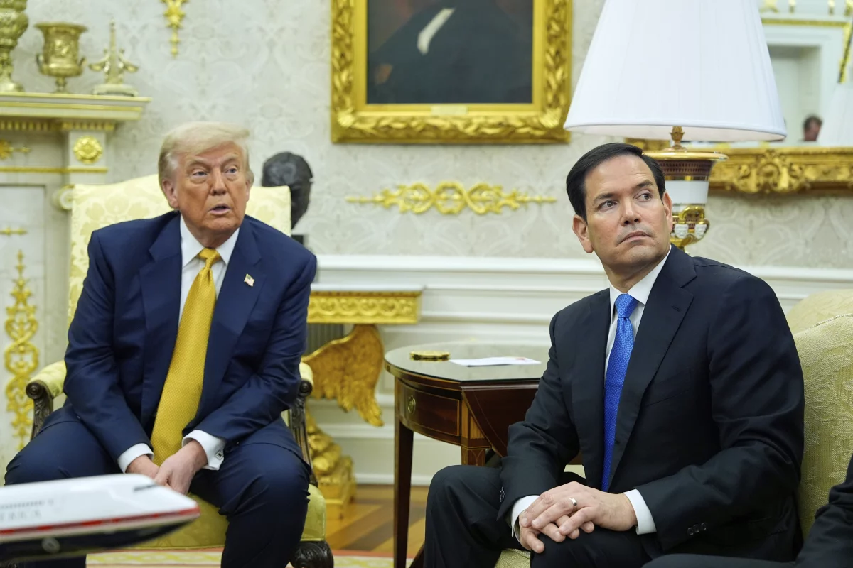 President Trump and Secretary of State Marco Rubio listen during an Oval Office meeting at the White House on July 16.