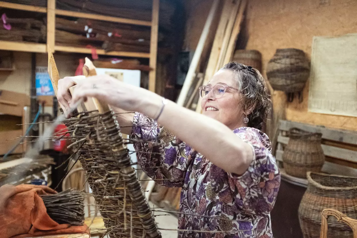 MaddyChristine Hope Brokopp weaves the bottom of a burial tray. Brokopp enlisted her friends to weave her tray after a cancer diagnosis.