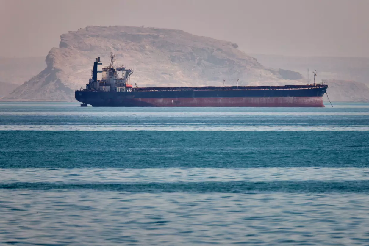 A bulk cargo ship sits at anchor in the Strait of Hormuz off Bandar Abbas, Iran, May 2.
