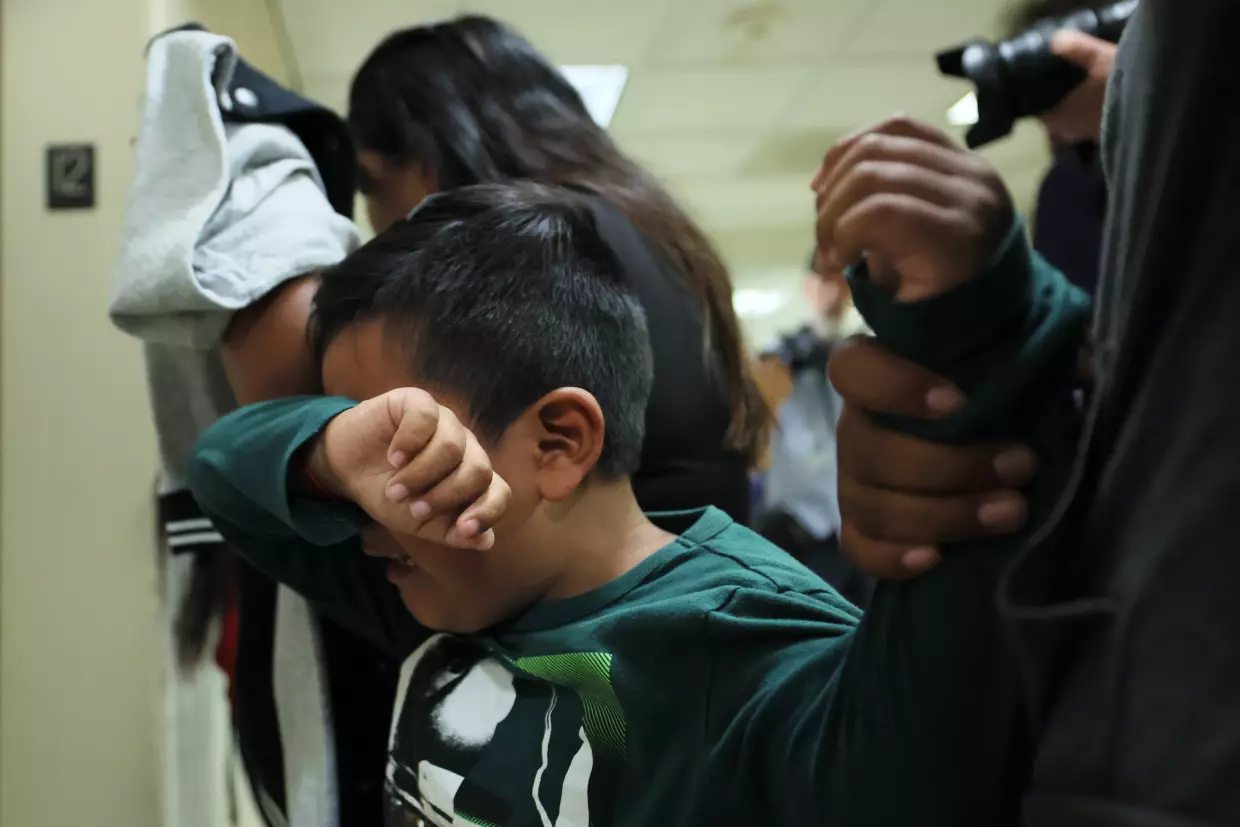 A child cries after his father is detained by federal agents as they left an immigration court hearing at the Jacob K. Javits Federal Building on August 26, 2025 in New York City. The Trump administration's immigration crackdown continues nationwide.