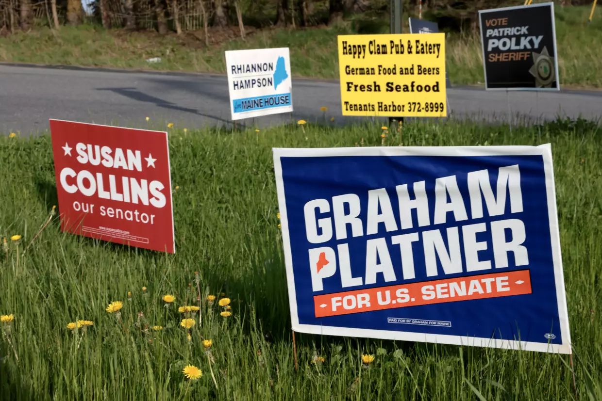Campaign signs sit next to a road in Rockport, Maine. Graham Platner is expected to be the Democratic nominee and would face off against incumbent Republican Sen. Susan Collins in the general election.