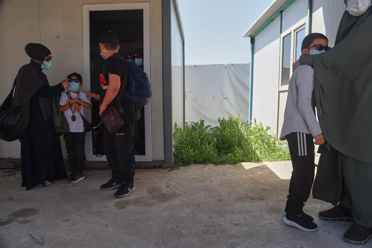 Members of Australian families at Roj Camp in eastern Syria, housing people with alleged ties to Islamic State militants, prepare to leave for Damascus as part of a second repatriation effort by Syrian authorities, Friday, April 24, 2026.