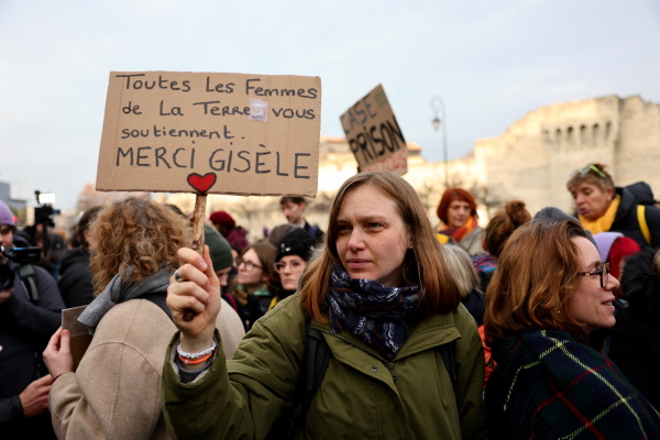 A woman holds a placard reading in French "All women on Earth support you, thank you Gisele" as people gathered outside the courthouse in Avignon, France, on Dec. 19, 2024, in advance of the verdicts being read out from the trial of an ex-husband and more than four dozen other men who were found guilty of aggravated rape against Gisèle Pelicot.