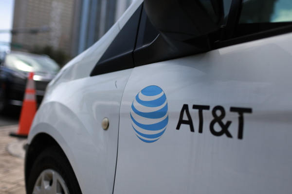 An AT&T logo adorns a worker's van on April 1 in Miami, Fla.
