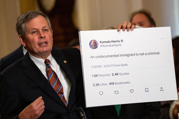 Sen. Steve Daines, R-Mont., holds up a tweet by Vice President Harris at a news conference at the Capitol on July 30, 2024.