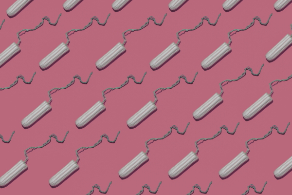 Diagonal rows of tampons against a pink background.
