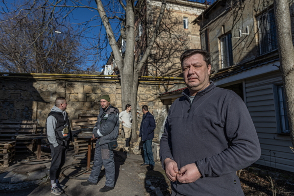 Danylo Tatarynov, head of internet company "Viner" with other company staff on the backyard of the company office. Viner still provides internet connection in Kherson.