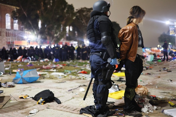 A California Highway Patrol officer detains a protestor while clearing a pro-Palestinian encampment at the University of California, Los Angeles, after university officials declared the camp unlawful.