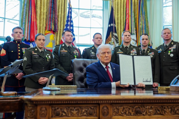 President Donald Trump poses with a recently signed executive order classifying fentanyl as a "weapon of mass destruction," during a ceremony in the Oval Office of the White House on Dec. 15.