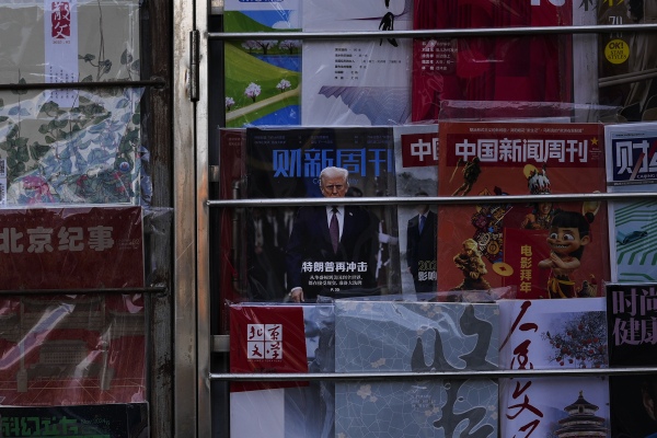 A magazine carrying a front cover of President Donald Trump with the words "Trump shock again" on display with other magazines at a bookstand in Beijing on Tuesday, Feb. 4.