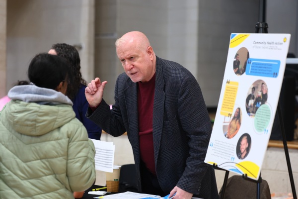 Employers speak with attendees during a job fair at the YMCA Gerard Carter Center in Staten Island in New York City on March 27, 2025. Employers continued to add jobs in March, but uncertainty over trade policy and softer spending by consumers could soon be a drag on hiring.