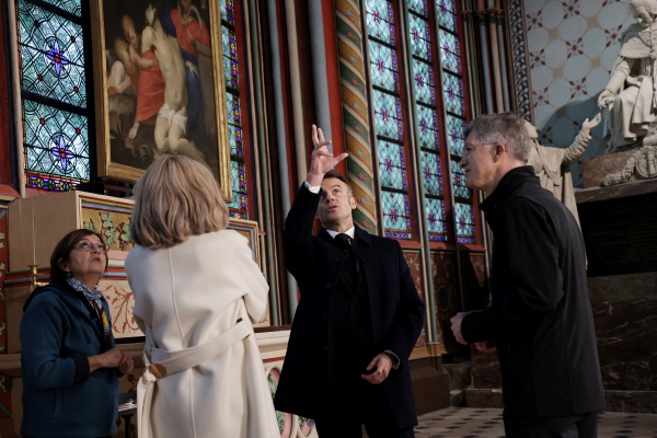 French President Emmanuel Macron and his wife Brigitte Macron (second from left), accompanied by President of the "Rebatir Notre-Dame de Paris" public establishment Philippe Jost (right) visit Notre Dame cathedral in Paris on Friday.