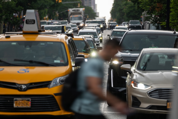 Pedestrians and cars move through midtown Manhattan traffic on June 6 in New York City. More than 94% of new vehicles in 2023 came with automatic emergency braking. And several other driver-assistance technologies are now standard in more than 90% of new cars, trucks and SUVs.