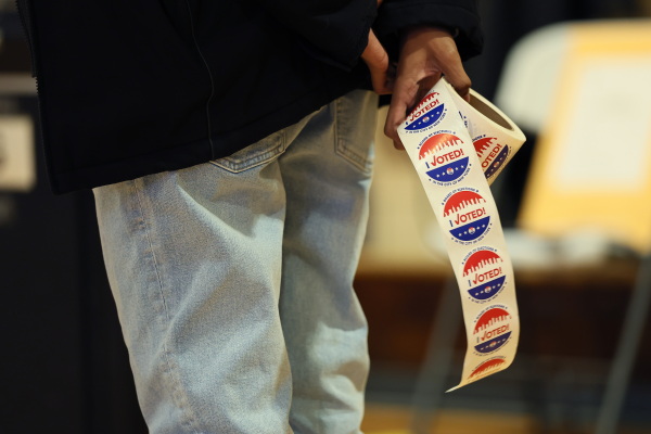 A poll worker holds "I Voted" stickers as people cast ballots on Nov. 4 in the Brooklyn borough of New York City.