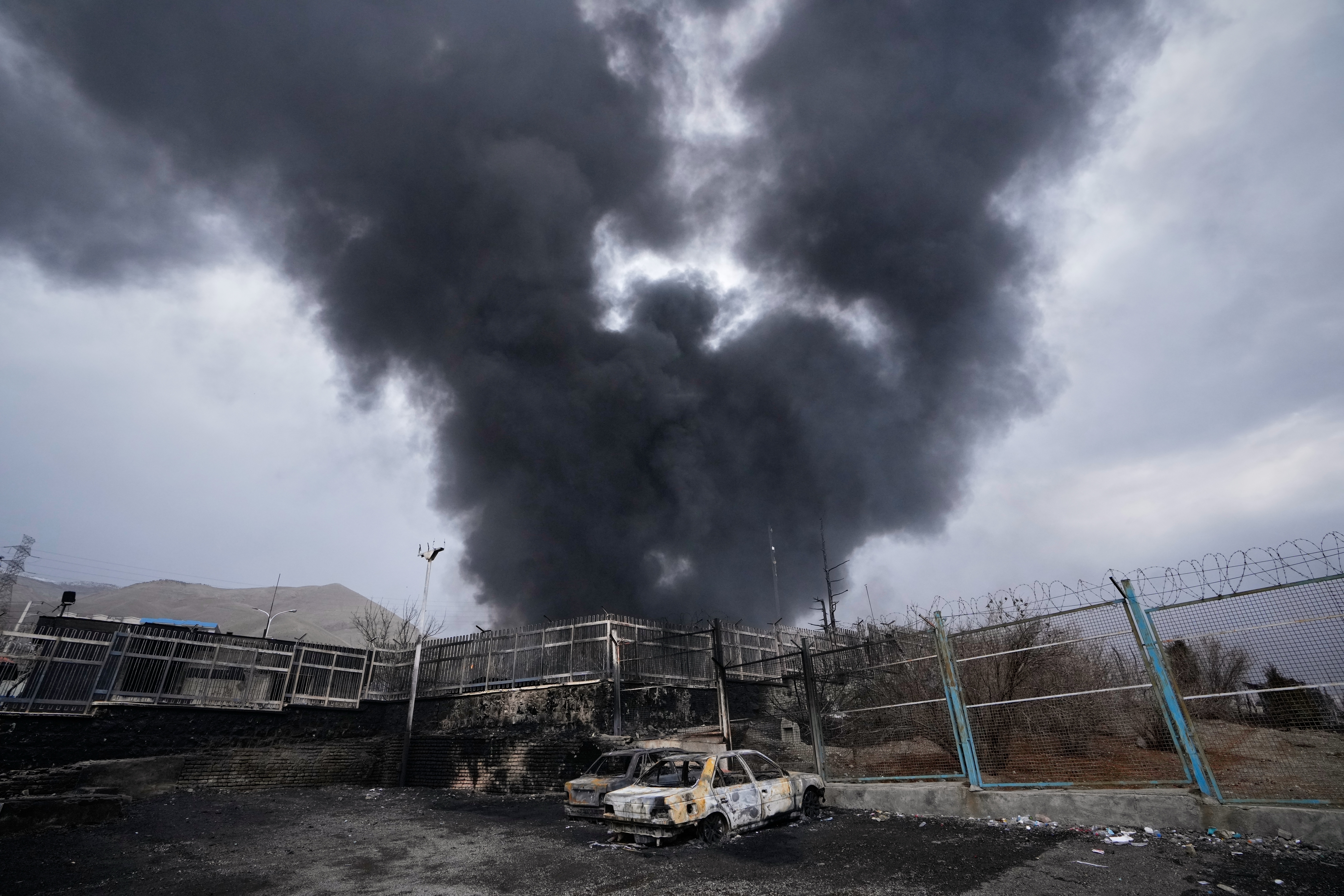 A thick plume of smoke rises from an oil storage facility hit by a U.S.-Israeli strike late Saturday in Tehran, Iran, Sunday, March 8, 2026. (AP)