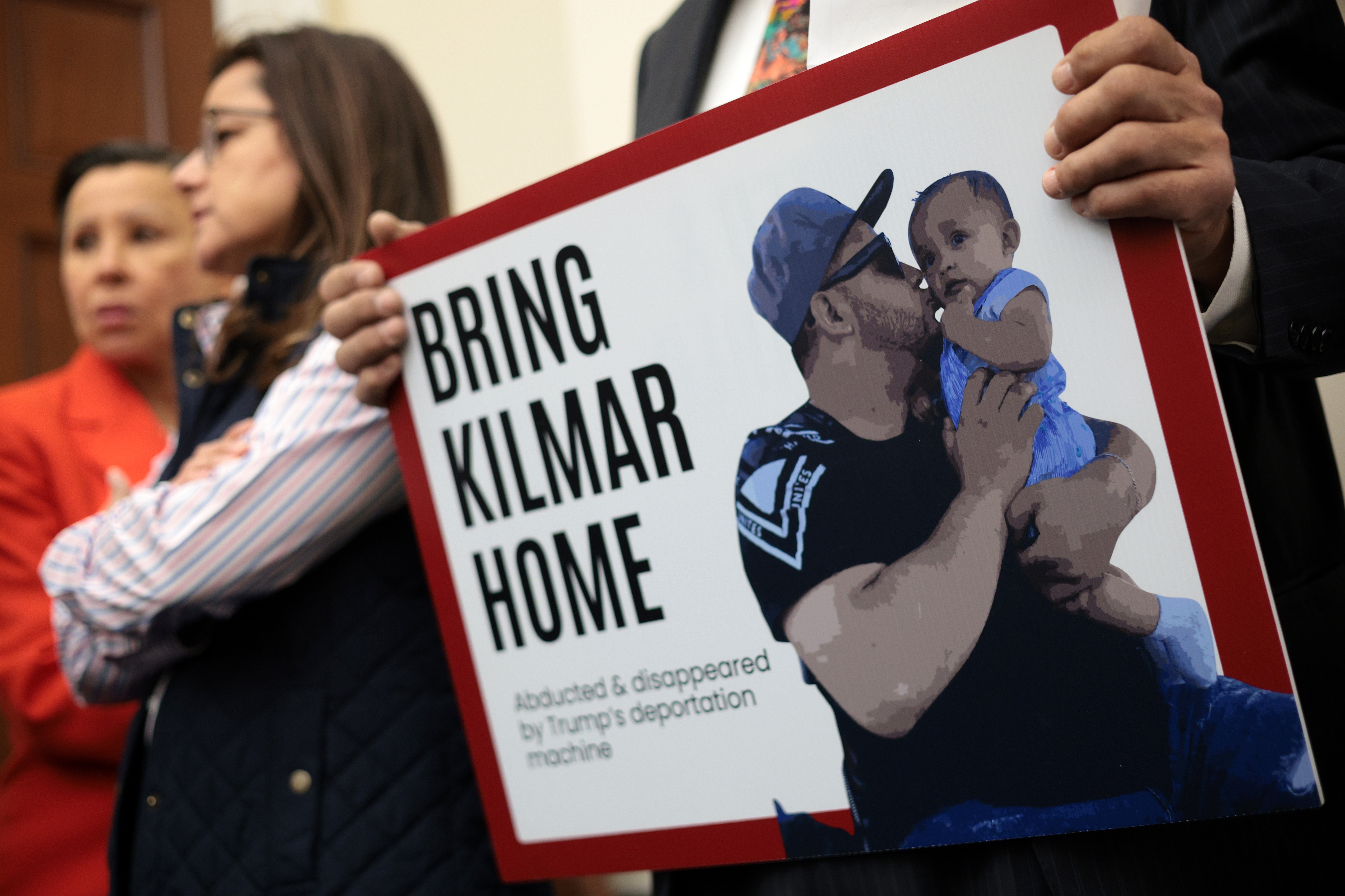 A member of the Congressional Hispanic Caucus holds a picture of Kilmar Abrego Garcia during a news conference to discuss his arrest and deportation on April 9 in Washington, D.C. The Trump administration wants to deport him to Uganda.
