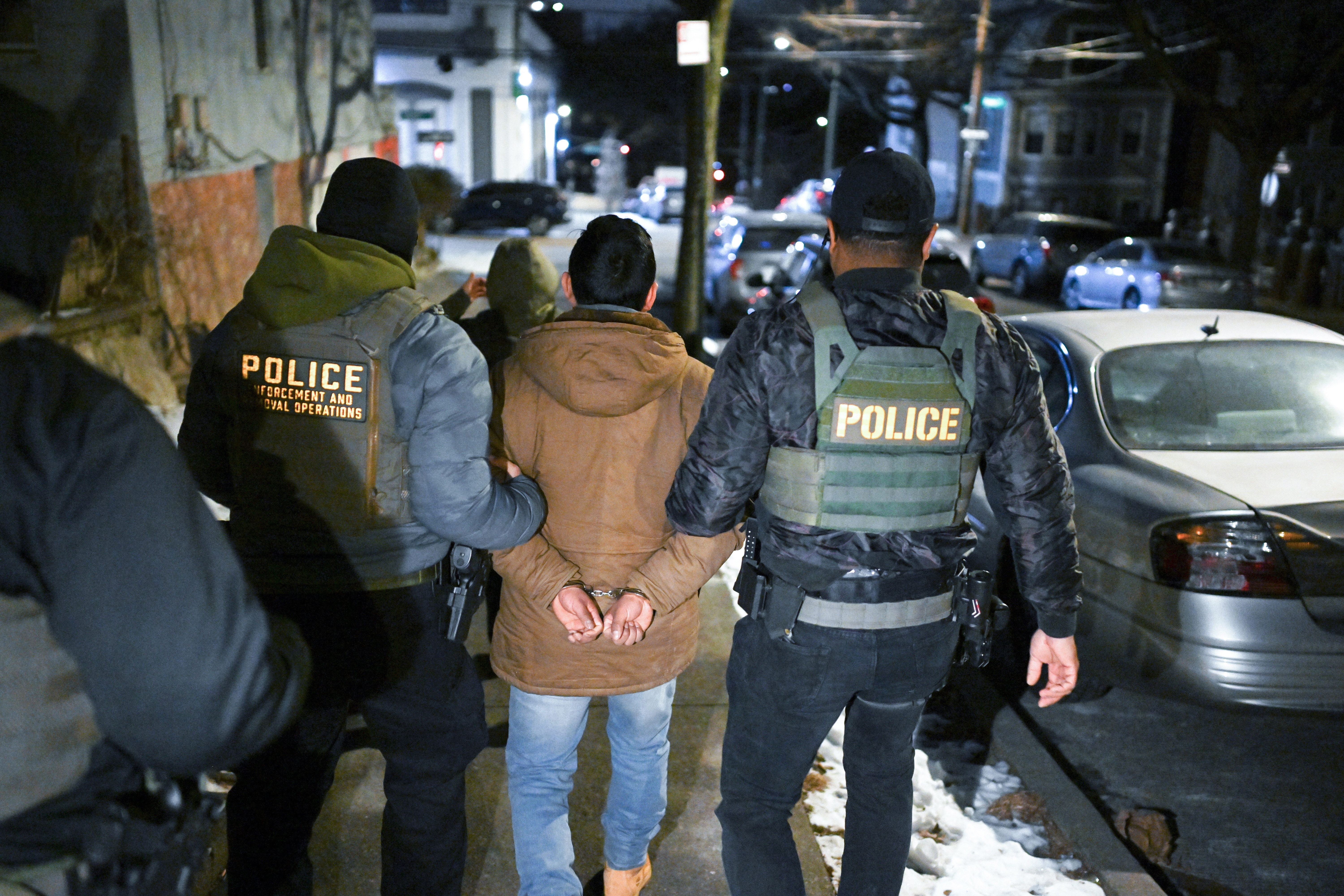 Law enforcement walk with Leonardo Fabian Cando Juntamay as he was detained in the Bronx during ICE-led operations to apprehend illegal immigrants on Jan. 28, 2025 in New York, NY.