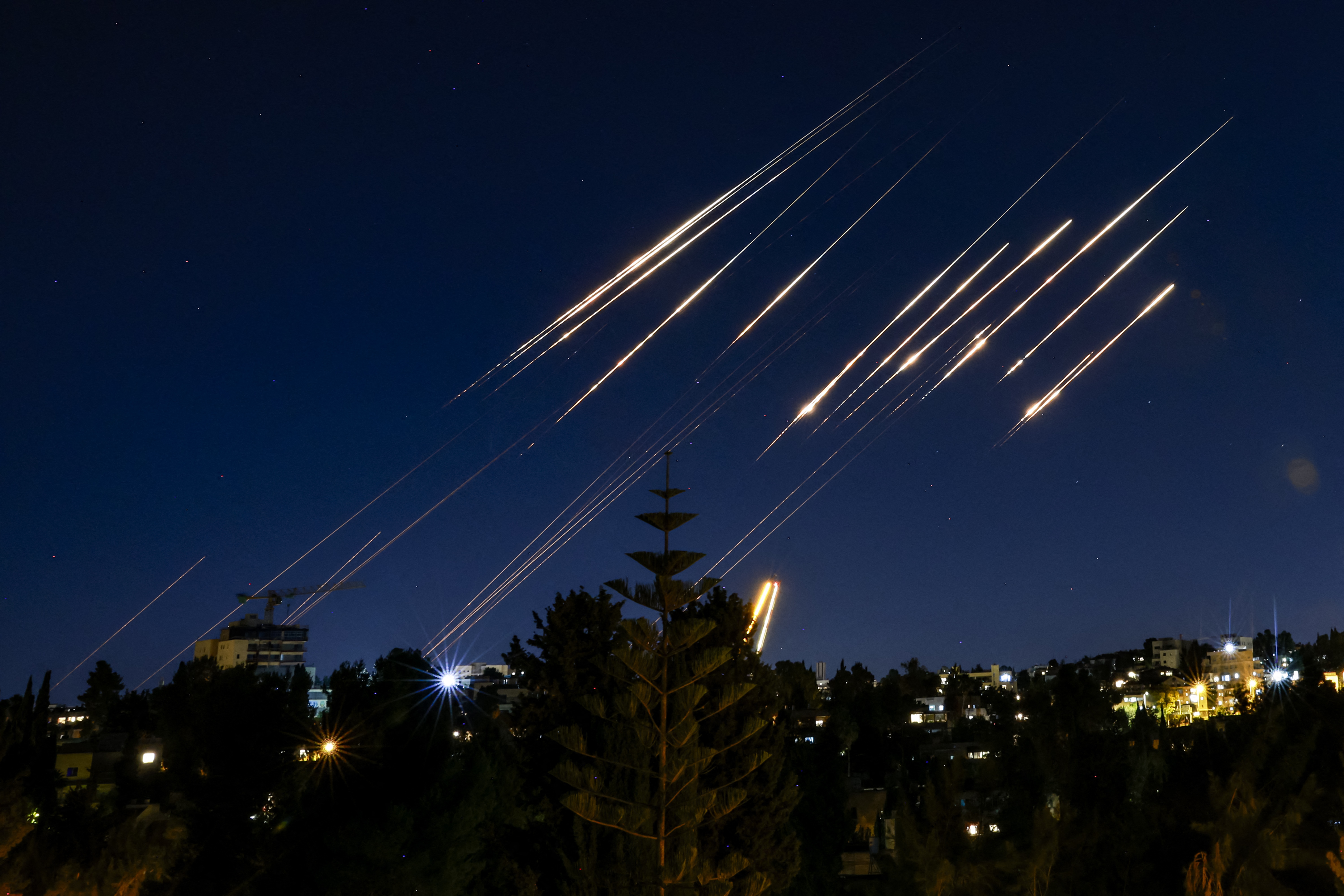 Missiles fired from Iran are pictured in the night sky over Jerusalem on June 14, 2025 as Israel and Iran exchanged fire a day after Israel unleashed an unprecedented aerial bombing campaign that Iran said hit its nuclear facilities, killed top commanders and dozens of civilians.