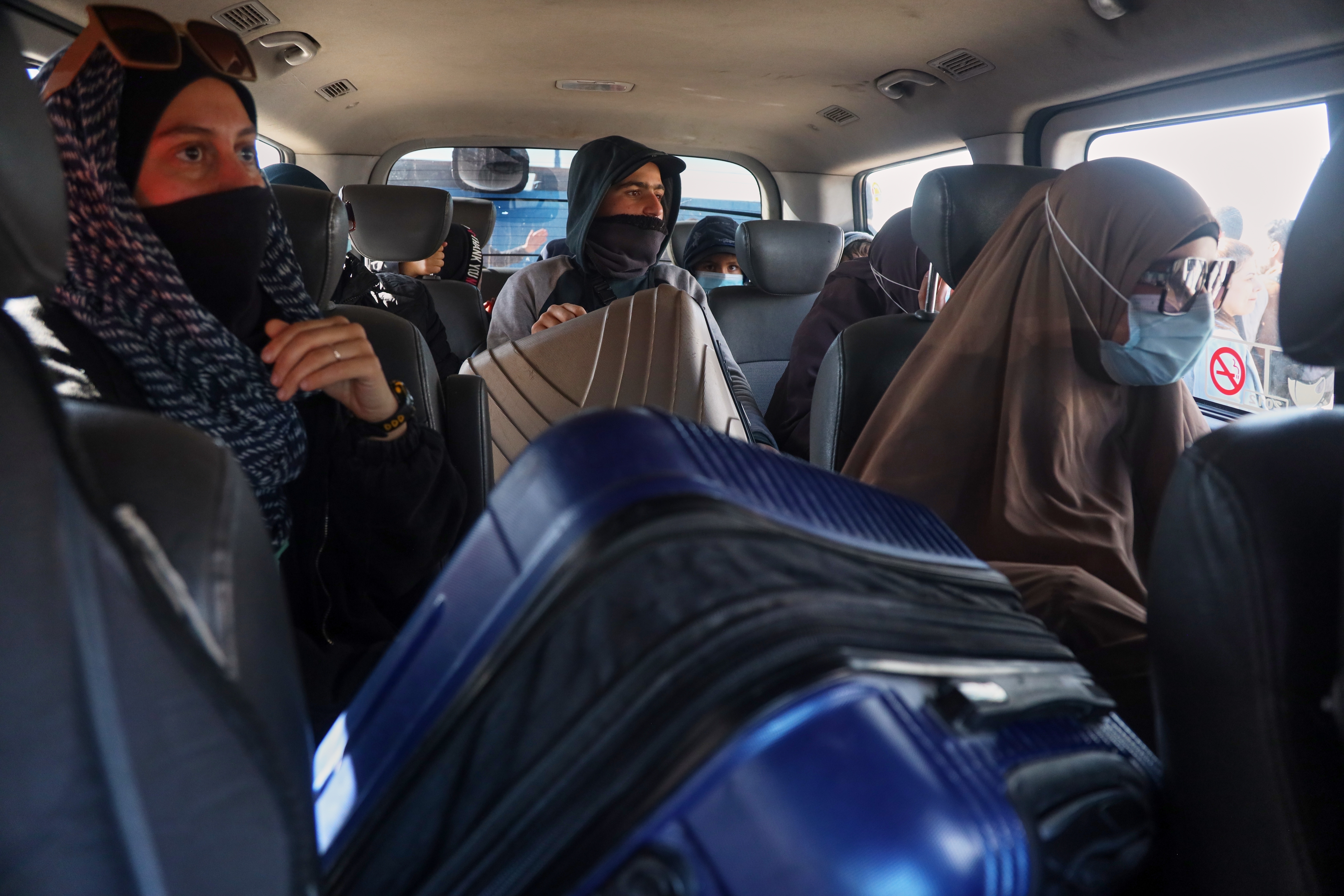 Family members of suspected Islamic State militants who are Australian nationals sit in a van heading to the airport in Damascus during the first repatriation operation of the year, at Roj Camp in eastern Syria, Monday, Feb. 16, 2026. Thirty-four Australian citizens from 11 families departed the camp.
