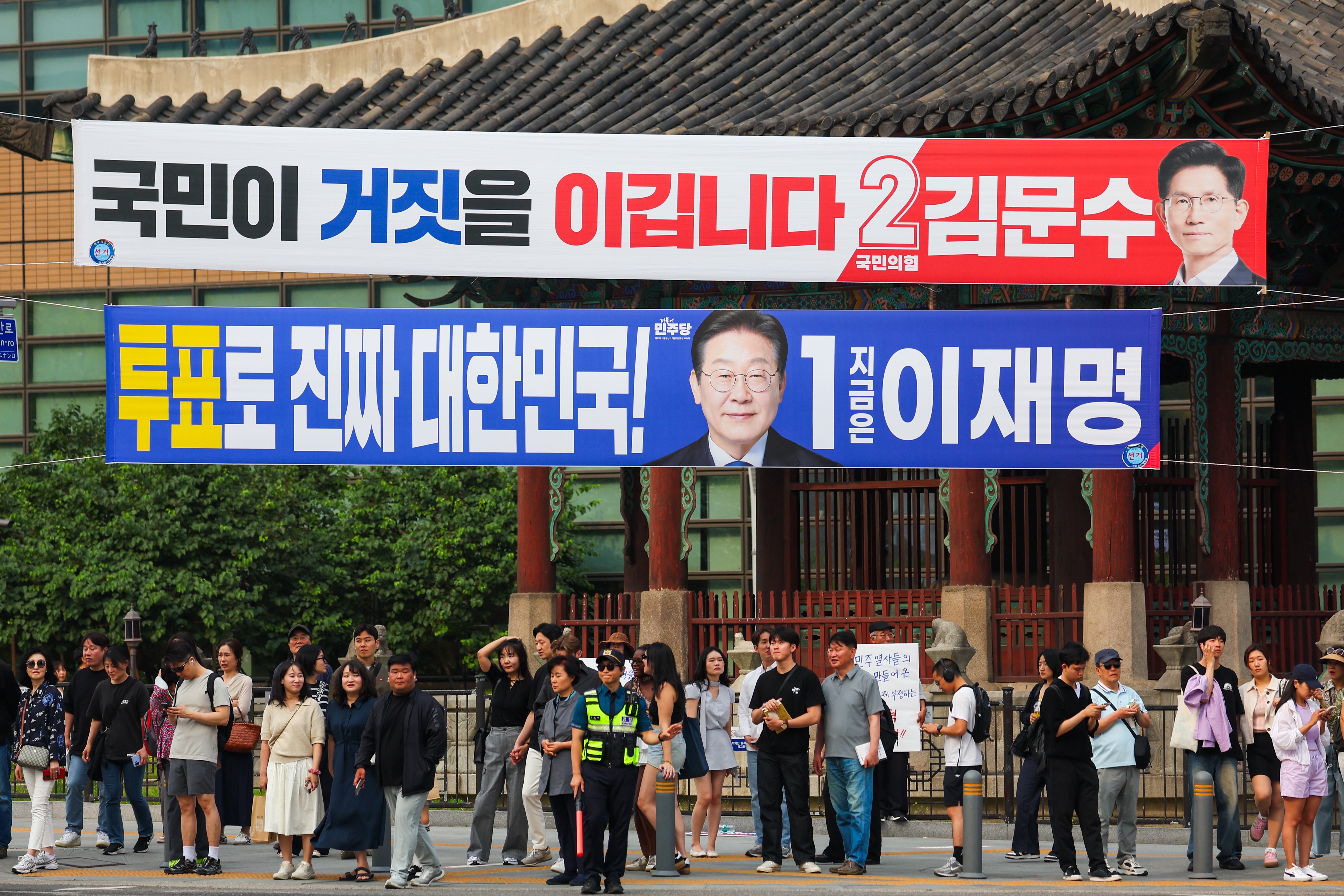 Election campaign banners for presidential candidates Lee Jae-myung of the Democratic Party of Korea and Kim Moon-soo of the People Power Party are seen on May 31 as the country