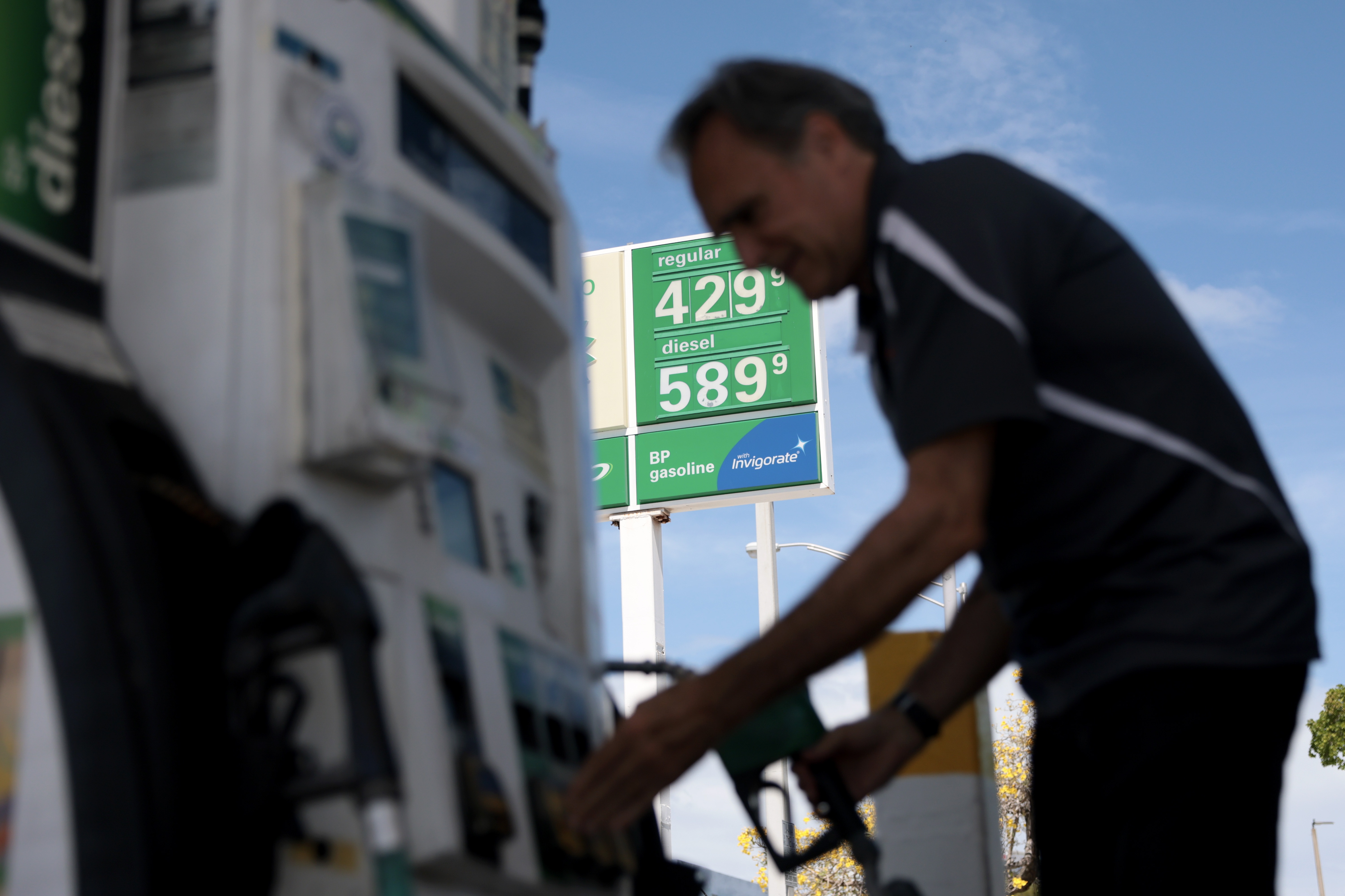 Carlos Ferre puts fuel in his vehicle at a gas station on April 06, 2026 in Miami, Florida. Florida gas prices have risen to over $4 per gallon in early April 2026 as the war in Iran has affected global oil supplies, leading to higher crude oil costs.