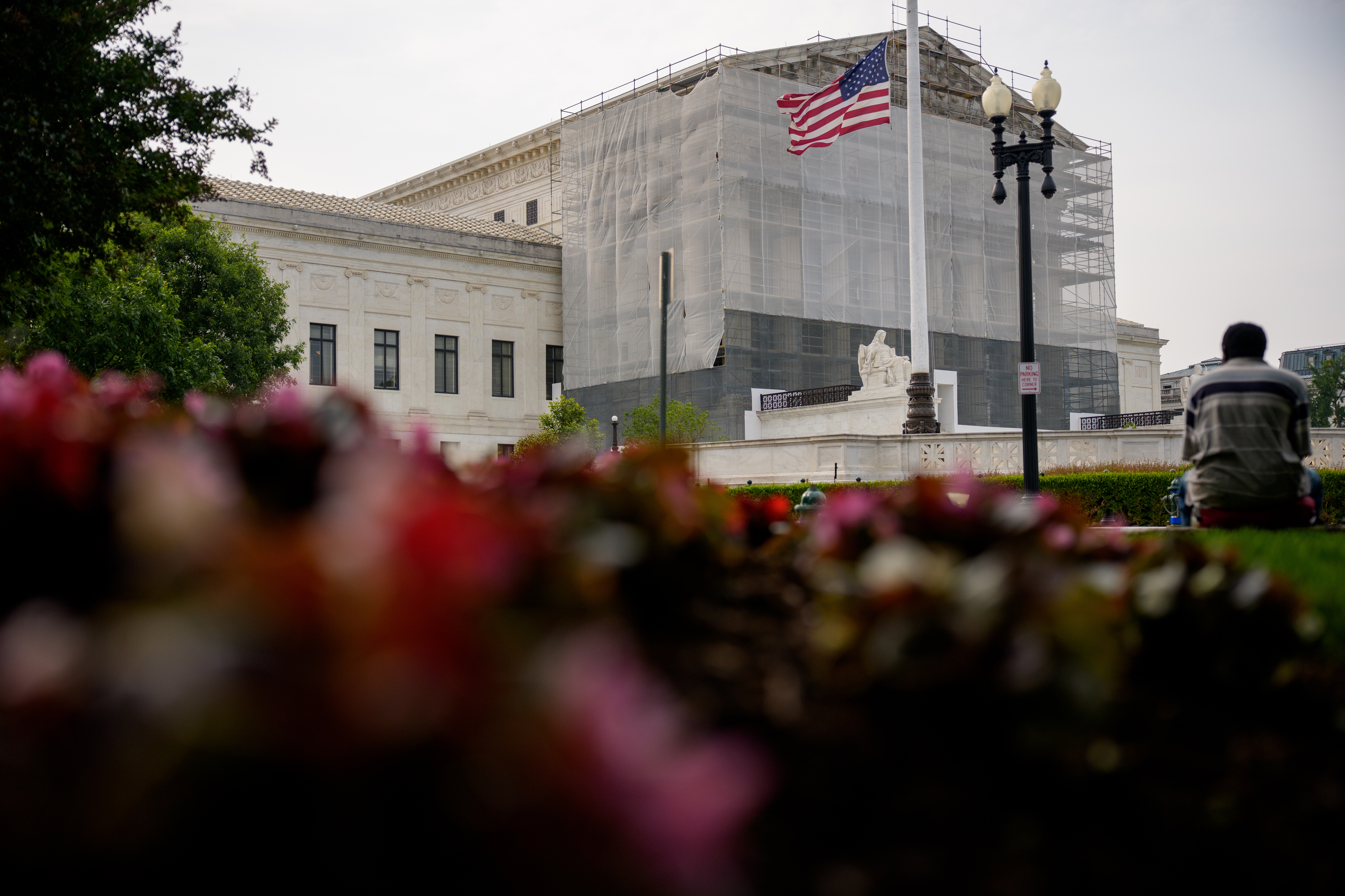 A person rests in front of the U.S. Supreme Court on June 5 in Washington, D.C.