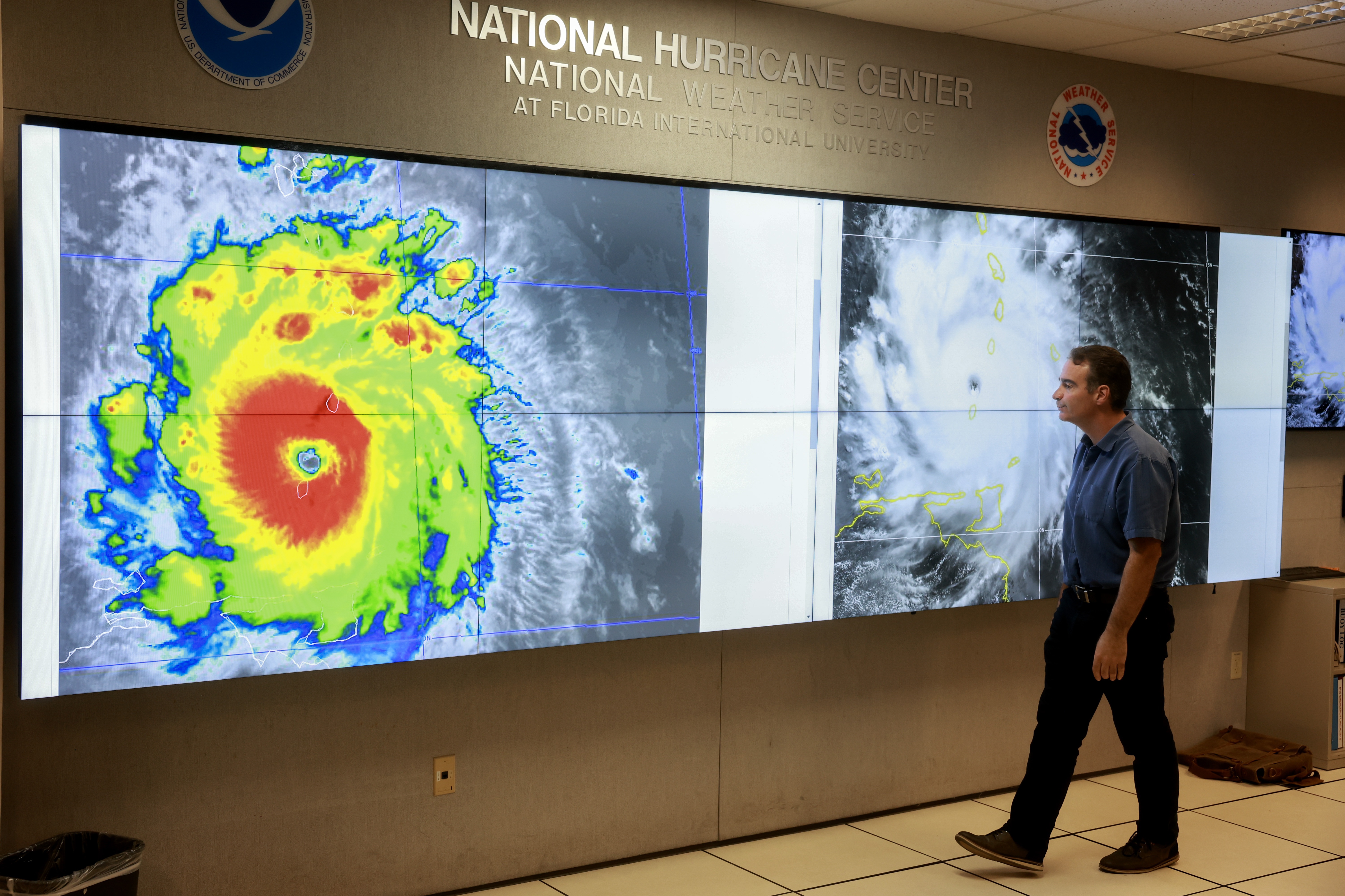 A hurricane specialist looks at a satellite image of Hurricane Beryl, the first hurricane of the 2024 season. The National Hurricane Center provides forecasts of major storms, many of which make landfall in the U.S.. The Center is part of NOAA, the country