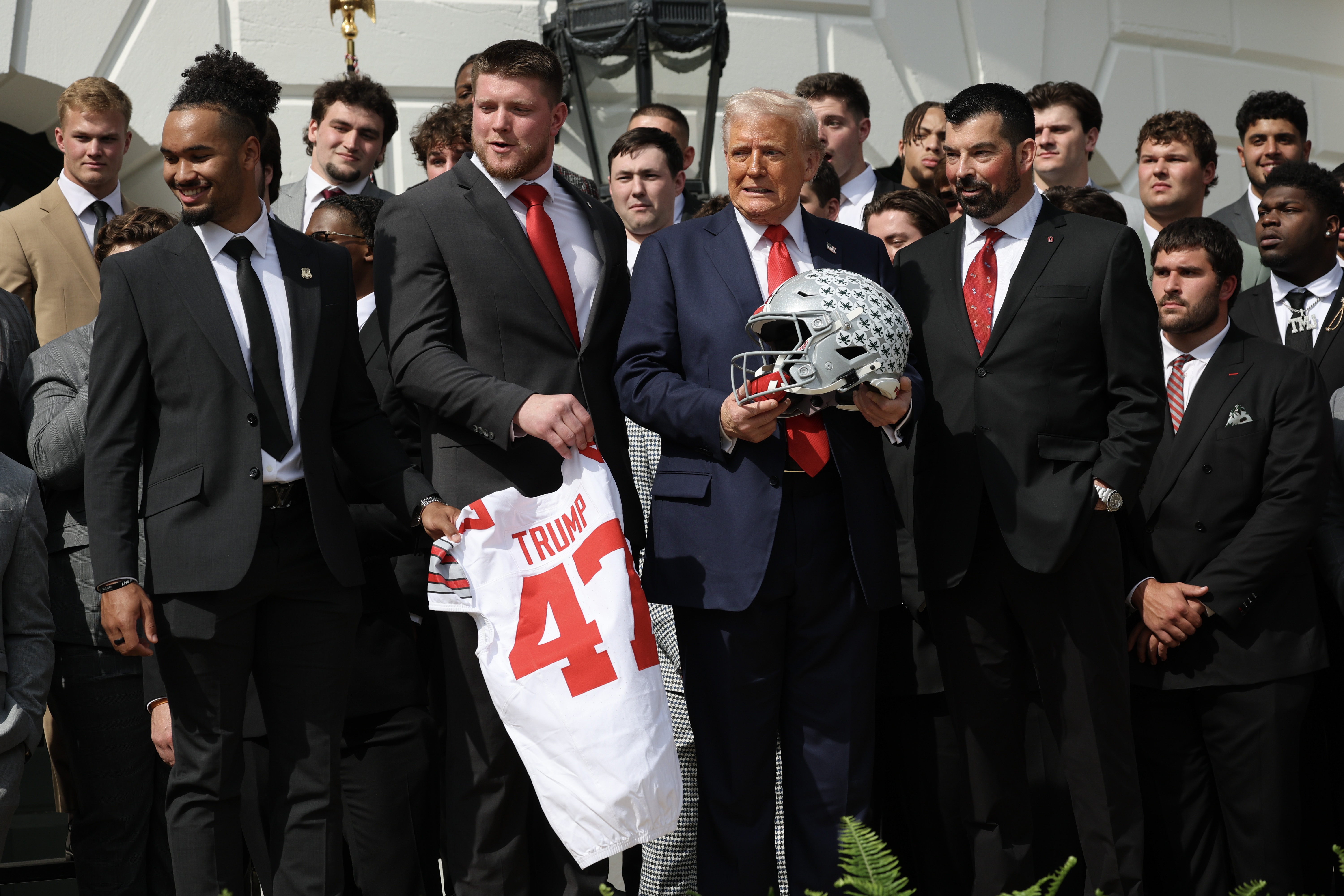 President Trump stands with Ohio State Head Coach Ryan Day (R) as he welcomed the 2025 College Football National Champions from Ohio State University to the White House during a ceremony on April 14, 2025 in Washington, DC. Trump
