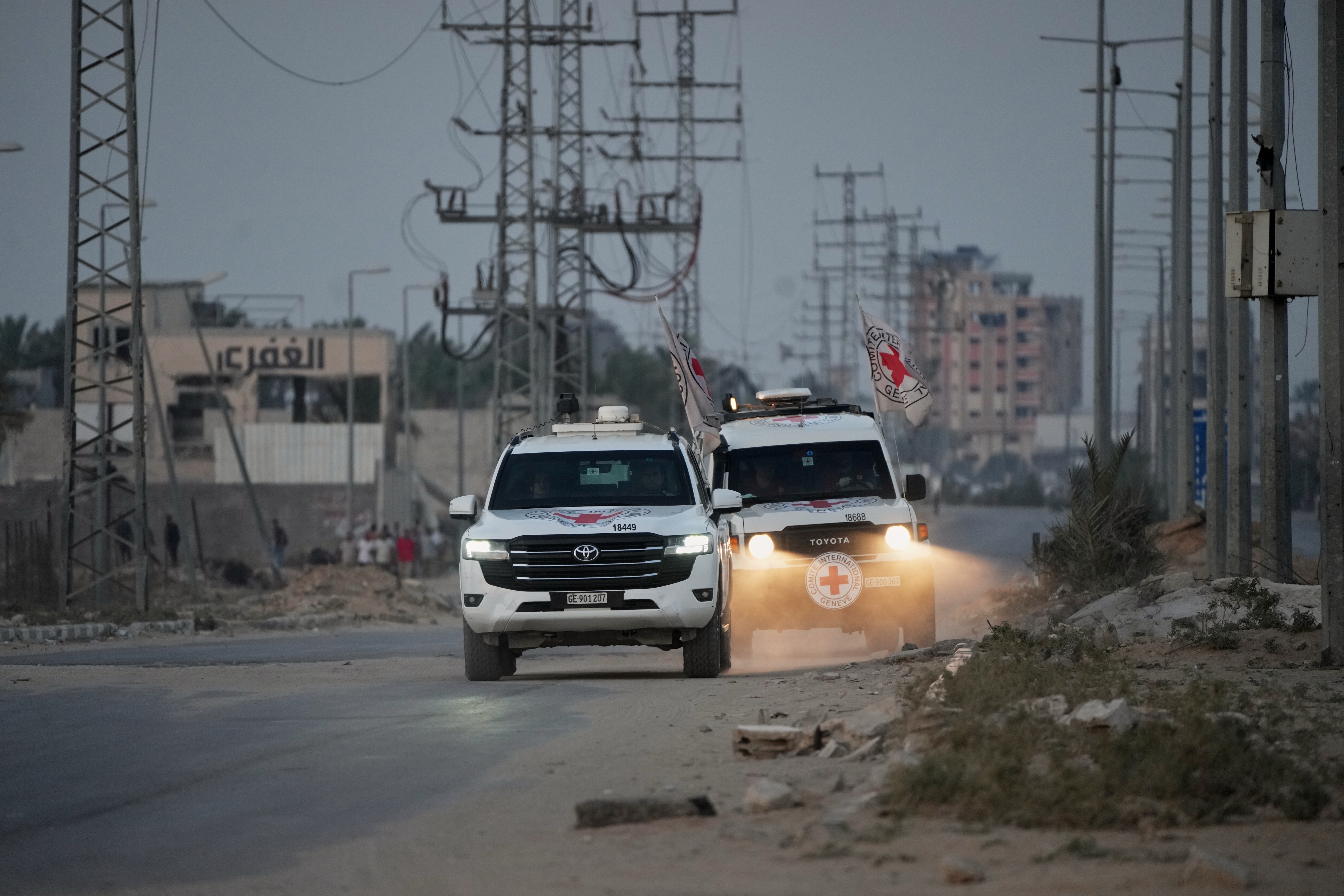 Red Cross vehicles carrying the bodies of people believed to be deceased hostages handed over by Hamas make their way toward the Kissufim border crossing with Israel, to be transferred to Israeli authorities, in Deir al-Balah, central Gaza Strip, on Thursday.