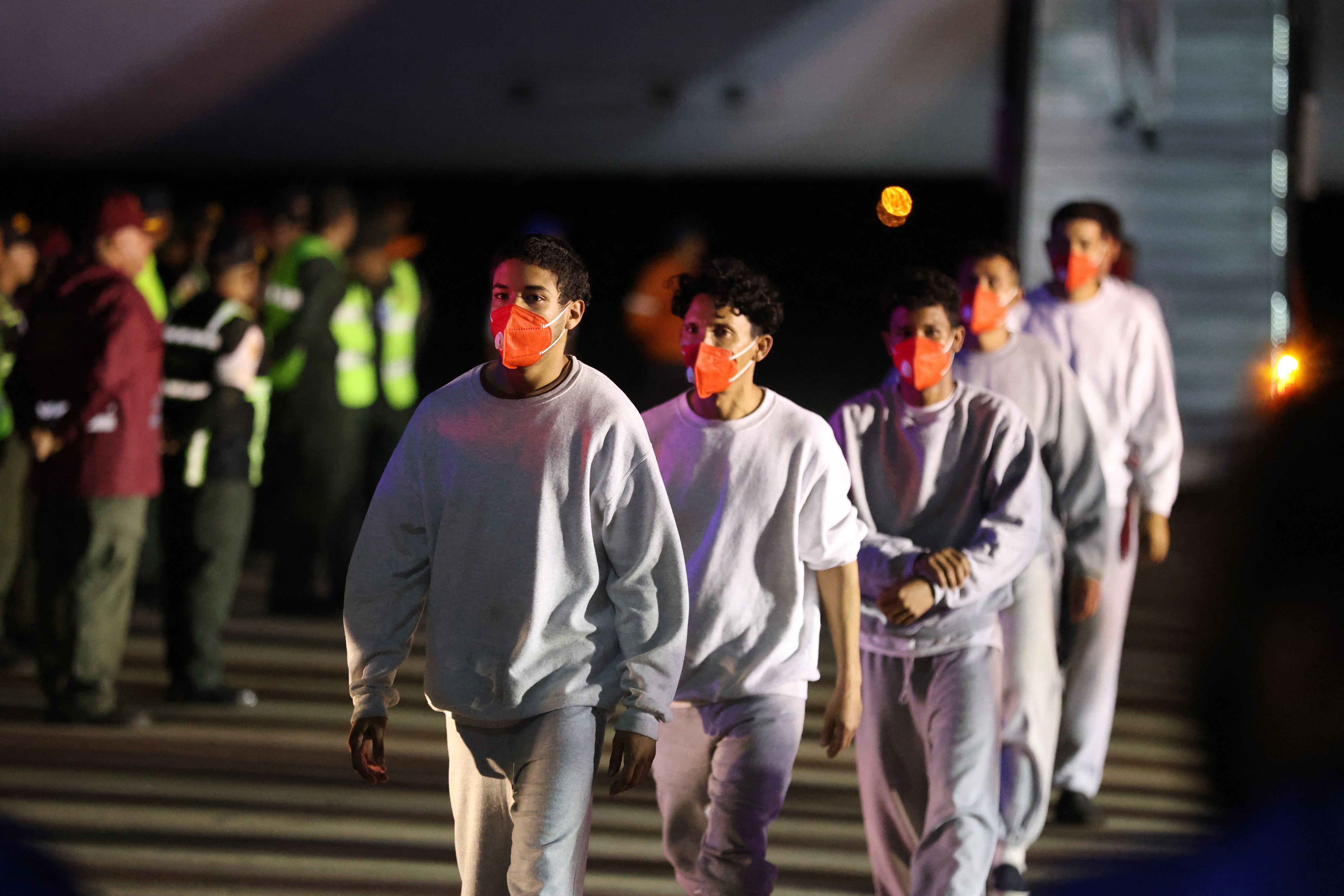 Venezuelan migrants deported from US Naval Station Guantanamo Bay walk down from the Venezuelan Conviasa Airlines plane as they arrive at Simon Bolivar International Airport in Maiquetia, Venezuela on February 20, 2025.