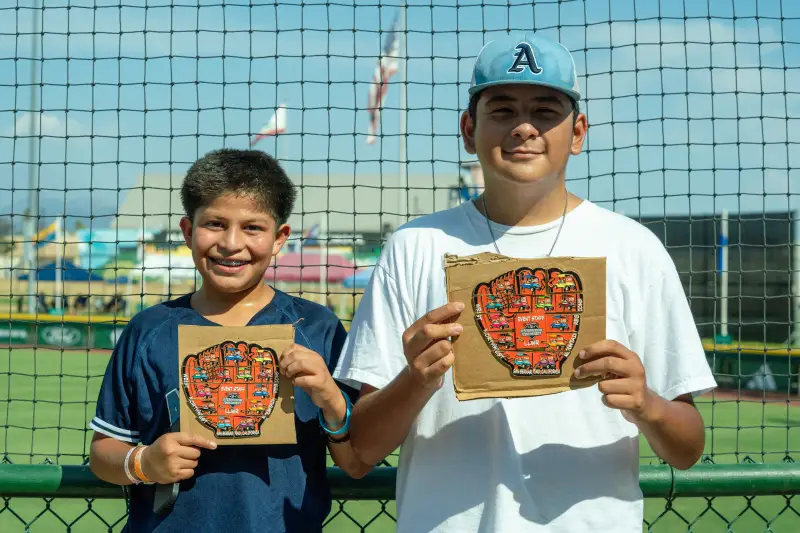 AJ Torres (left) and Antonio Castaneda (right) holding their completed pin sets (Maile Palacios/KVCR Public Media)