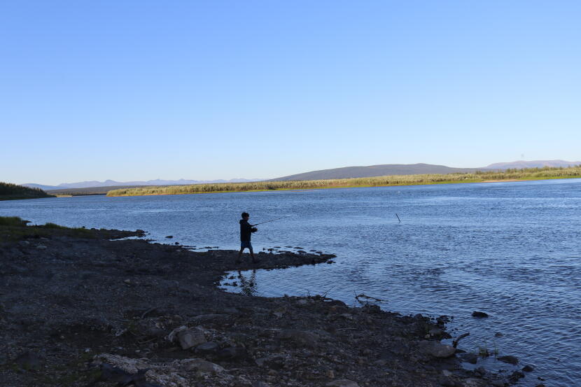 A boy fishes for salmon and sheefish along the Kobuk River near Ambler on July 24, 2026. Many opponents of mining in the Upper Kobuk region cite concerns about the potential effects of mining on subsistence activities.